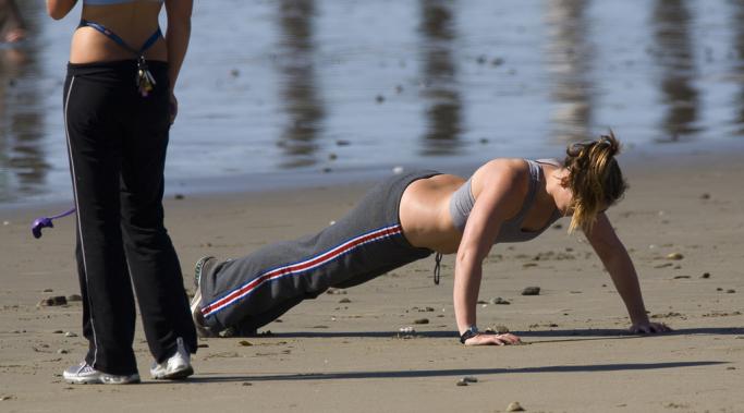 two-girls-exercising-cayucos-beach1 by Mike Baird